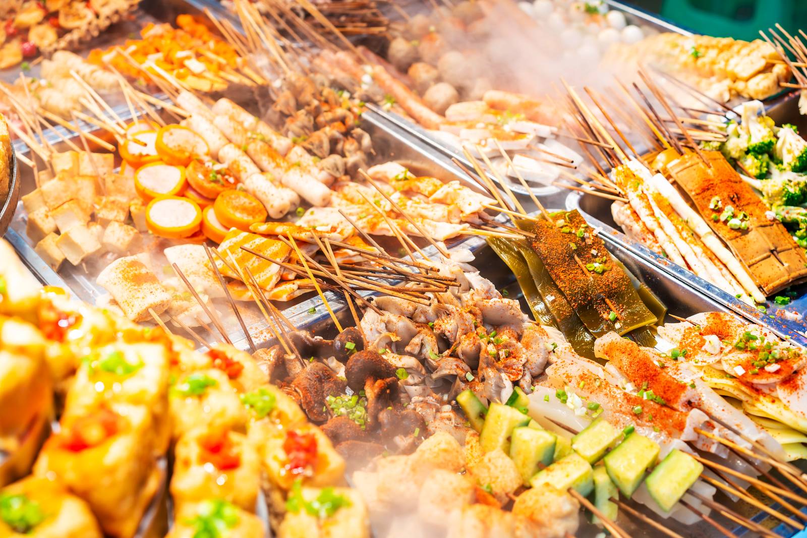 Trays of assorted chuan chuan skewers on display at a street stall